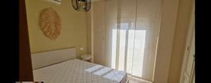 a small bedroom with a bed and a window at Villa Guzi in Orihuela Costa