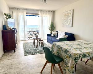 a living room with a blue couch and a table at Rives dor 1C in Juan-les-Pins
