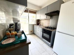 a kitchen with a counter with a tray of food at Rives dor 1C in Juan-les-Pins