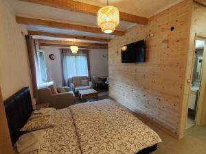 a bedroom with a bed and a flat screen tv at Apartments & Rooms Bojic in Kolašin