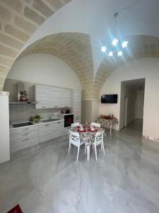 a kitchen with a table and chairs in a room at La Volta di Chiara in Roccaforzata