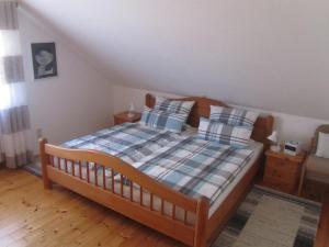 a bedroom with a wooden bed with two pillows at Fewo Glaser in Lug