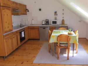a kitchen with a table and chairs in a kitchen at Fewo Glaser in Lug