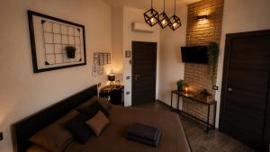 a living room with a couch and a brick wall at LoFT in Bosa