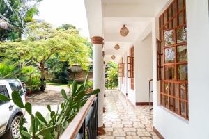 a hallway of a house with a balcony at Kivulini Homes in Arusha +7 photos