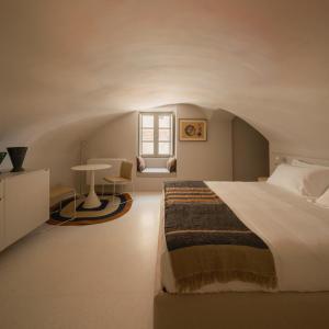 a bedroom with a large bed and a window at Sant'Angelo Ostuni - Il Palazzo in Ostuni +32 photos
