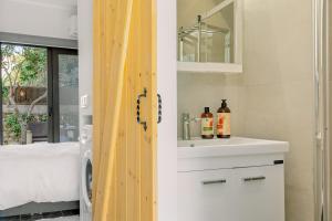 a bathroom with a sink and a mirror at InTown Suite in Lefkada +26 photos