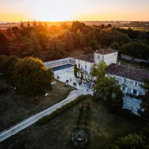 an aerial view of a building with a sunset in the background at Le clos de Bellevue in Mortagne-sur-Gironde