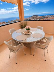 a table and chairs on a balcony with a view at Best Ocean View & Sunset - Los Cristianos in Los Cristianos