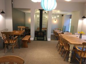 a dining room with wooden tables and chairs at Portreath Arms in Portreath
