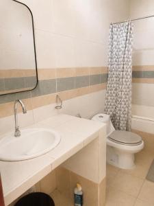 a bathroom with a sink and a toilet at Amazon City House Iquitos in Iquitos