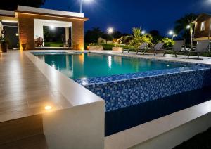 a swimming pool in a house at night at Villa la Santa, piscina infinita - Jacuzzi in Higuey