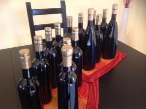 a bunch of wine bottles sitting on a table at Pisceneris Holiday Home in Uras