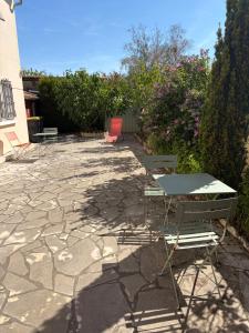 a table and chairs sitting on a stone patio at appartement avec 2 suites parentales in Angoulême