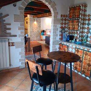 a restaurant with a table and chairs in a kitchen at Domus Liberty Luxury House in Sala Consilina