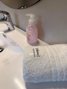 a roll of toilet paper sitting on a bathroom sink at Reine Viewpoint House in Reine +23 photos