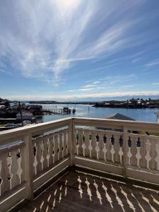 a balcony with a view of the water at Reine Viewpoint House in Reine