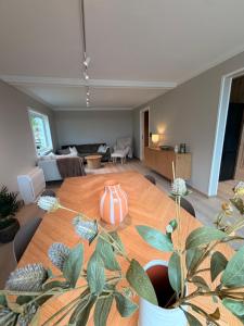 a room with a wooden table with a vase on it at Reine Viewpoint House in Reine