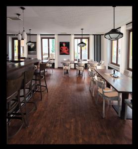 a large dining room with tables and chairs at Neros Hotel in Siegenburg