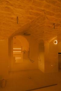 a bathroom with a shower in a room with a wooden ceiling at Sant'Angelo Ostuni - Il Palazzo in Ostuni