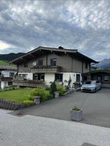 a house with a car parked in front of it at Haus Asslaber in Hochfilzen