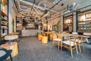 a restaurant with tables and chairs in a room at Baker Balcony Apartment in Brno