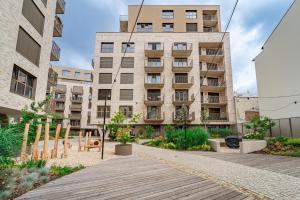 an apartment building with a wooden walkway in front of it at Baker Balcony Apartment in Brno