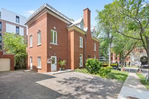 a brick building with a driveway in front of it at Manoir de la Tour - Par Aneyro in Quebec City