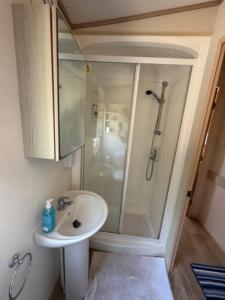 a bathroom with a shower and a sink at Beachcomber's Paradise in Castlegregory