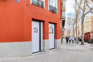 an orange building with two doors on a street at Maravilloso estudio en pleno centro in Madrid +5 photos