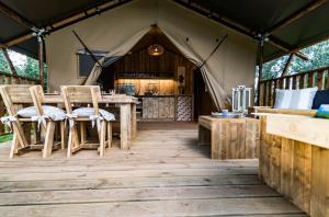 a room with a table and chairs in a tent at Glamping Tenuta Poggio Rosso in Populonia +22 photos