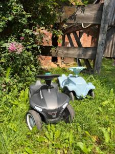 two toy vehicles are sitting in the grass at Lieblingsnest in Bad Fallingbostel