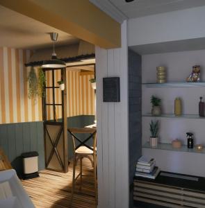 a room with a door and a table with a chair at L Atelier Secret in Guebwiller