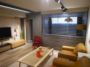 a living room with a couch and a table at L Atelier Secret in Guebwiller