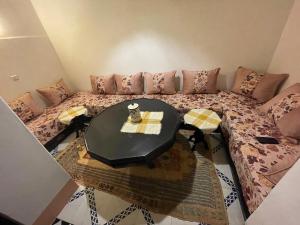 a living room with a couch and a table at Riad Marrakech Palacito in Marrakesh