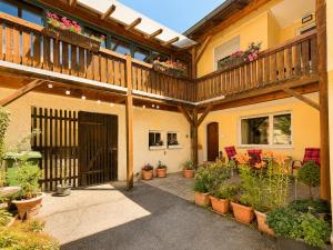 a patio with potted plants and a wooden deck at Altmühl Hideaway Apartment 1 in Treuchtlingen