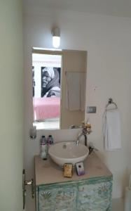 a bathroom with a sink and a mirror at Dahabiya cruise in Luxor
