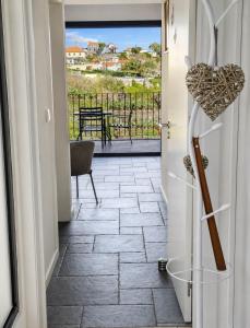 a hallway with a door leading to a patio with a table at Villa Bavaria C in Ponta do Sol