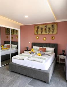 a bedroom with a large bed with two mirrors at Villa Bavaria C in Ponta do Sol