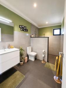 a bathroom with a toilet and a sink at Villa Bavaria C in Ponta do Sol