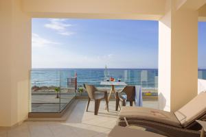 a dining room with a view of the ocean at SEPERI Deep Blue in Rethymno