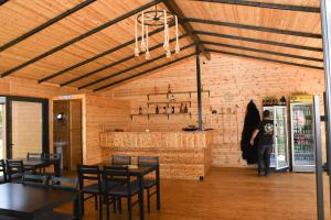a woman standing in a restaurant with a basketball hoop at Vatra Traditional Guesthouse in Lekdush +27 photos