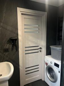 a bathroom with a washing machine and a washer at Foresthillсоttage in Tyshovnitsa +20 photos