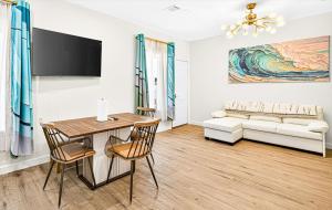 a living room with a table and a couch at Ninas Villas - Brand New Luxury Villas in Galveston