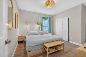 a bedroom with a bed and a table and a window at Ninas Villas - Brand New Luxury Villas in Galveston
