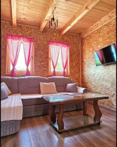 a living room with a couch and a table at Vikendice Una i Andrea in Bileća