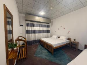 a small room with a bed and a window at Afaa Beach Guest House in Arugam Bay +17 photos