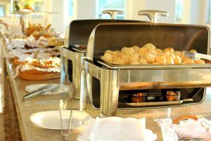 a buffet line with pastries and other food items at Lacqua DiRoma - Acesso livre ao Park Aquático - Central de Reservas in Caldas Novas