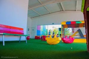 a play room with three slides and a playground at Lacqua DiRoma - Acesso livre ao Park Aquático - Central de Reservas in Caldas Novas