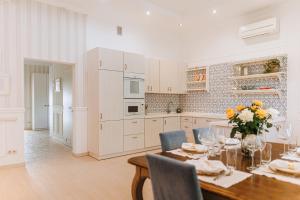 a kitchen with a table and chairs and a kitchen with white cabinets at Otte in Myrhorod